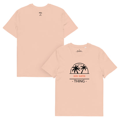 Peach coloured  t-shirt with palm tree design and text on a white background