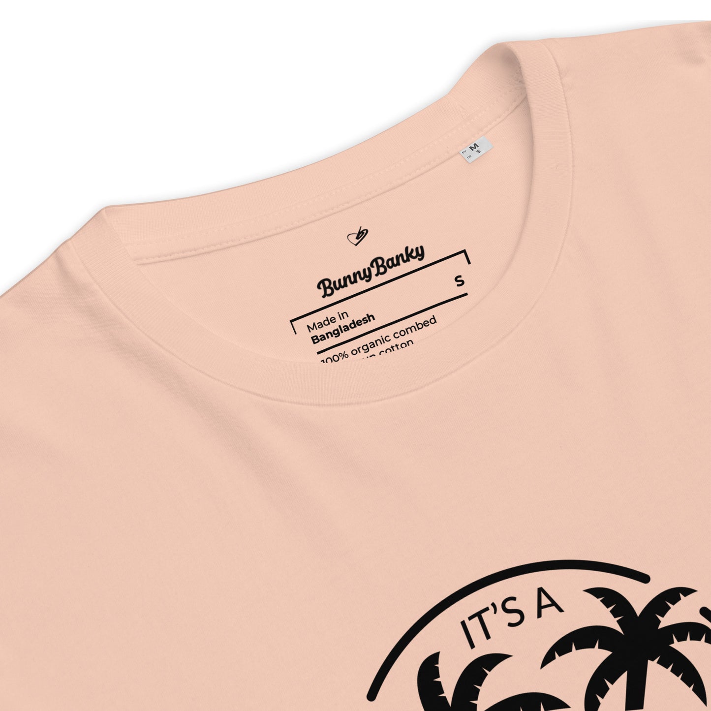 Close-up of a peach-colored t-shirt with a palm tree design and Bunny Banky branding.