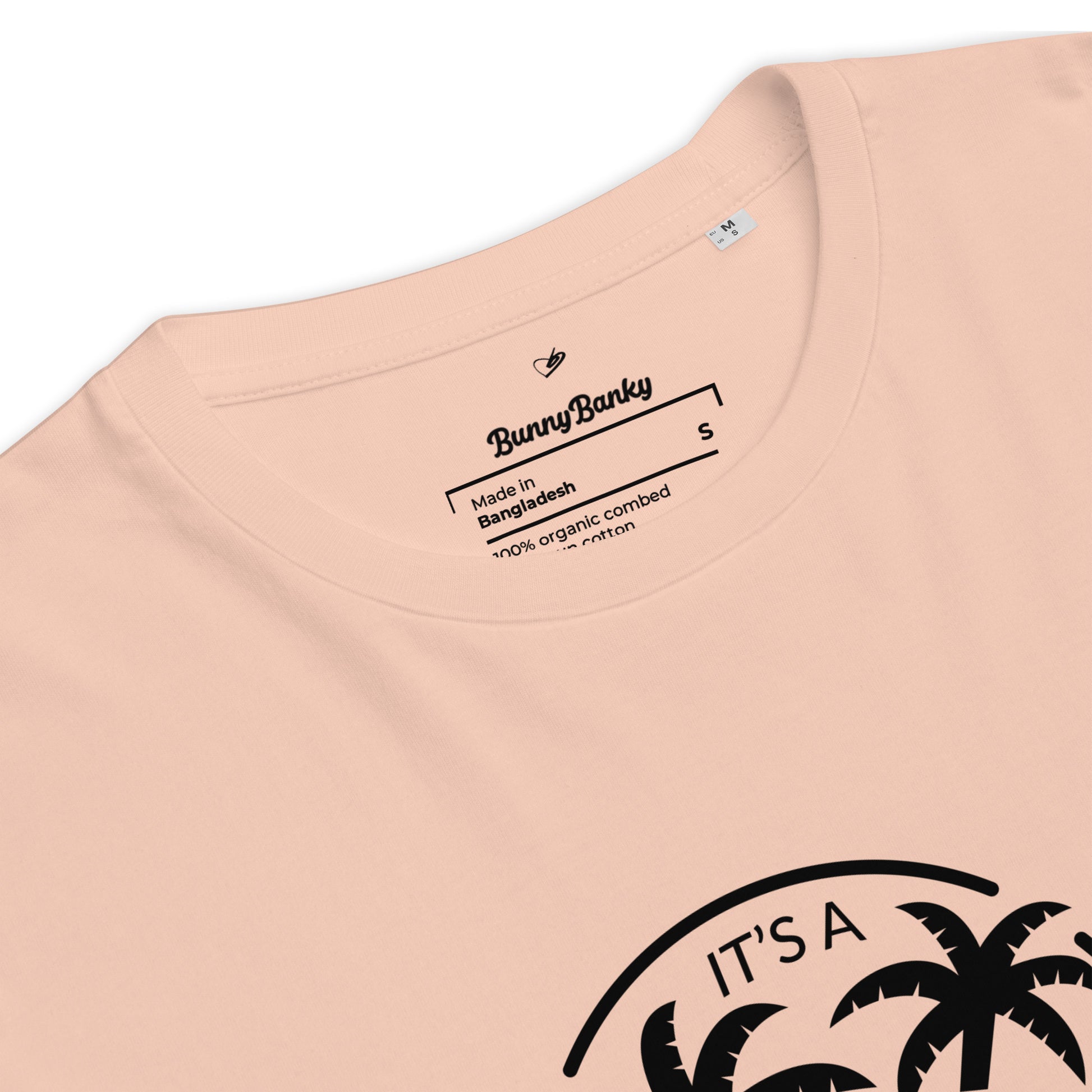 Close-up of a peach-colored t-shirt with a palm tree design and Bunny Banky branding.