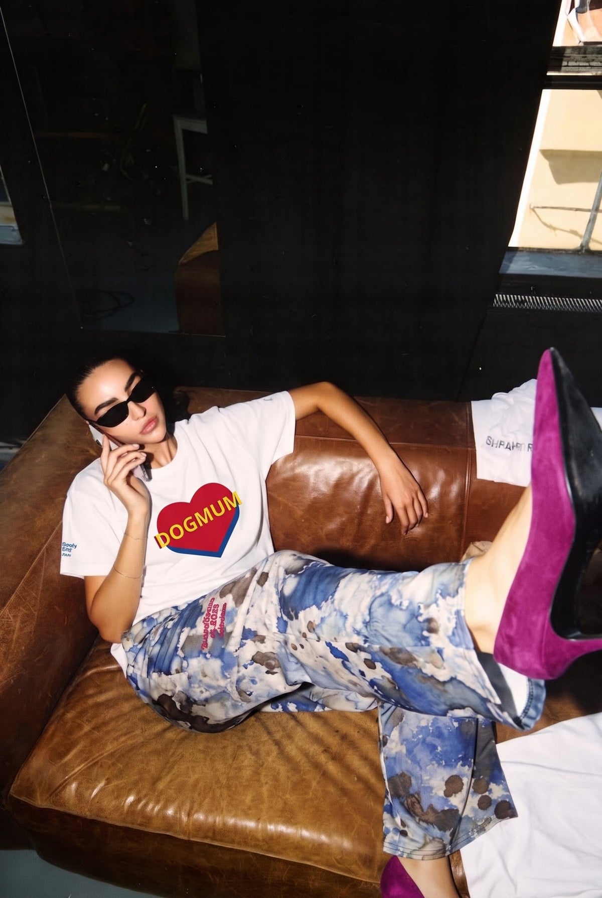 Bunny Banky Model wearing the Dogmum Organic Tee in white organic ring-spun cotton t-shirt featuring a red and blue heart with yellow DOGMUM text across the chest and the Amali Flow Joggers