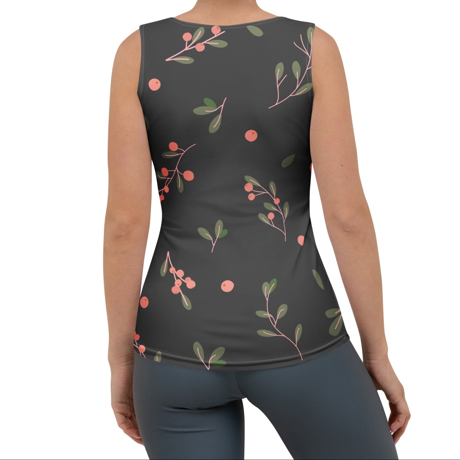 Woman wearing a brown sleeveless top with a decorative pink  design on a white background