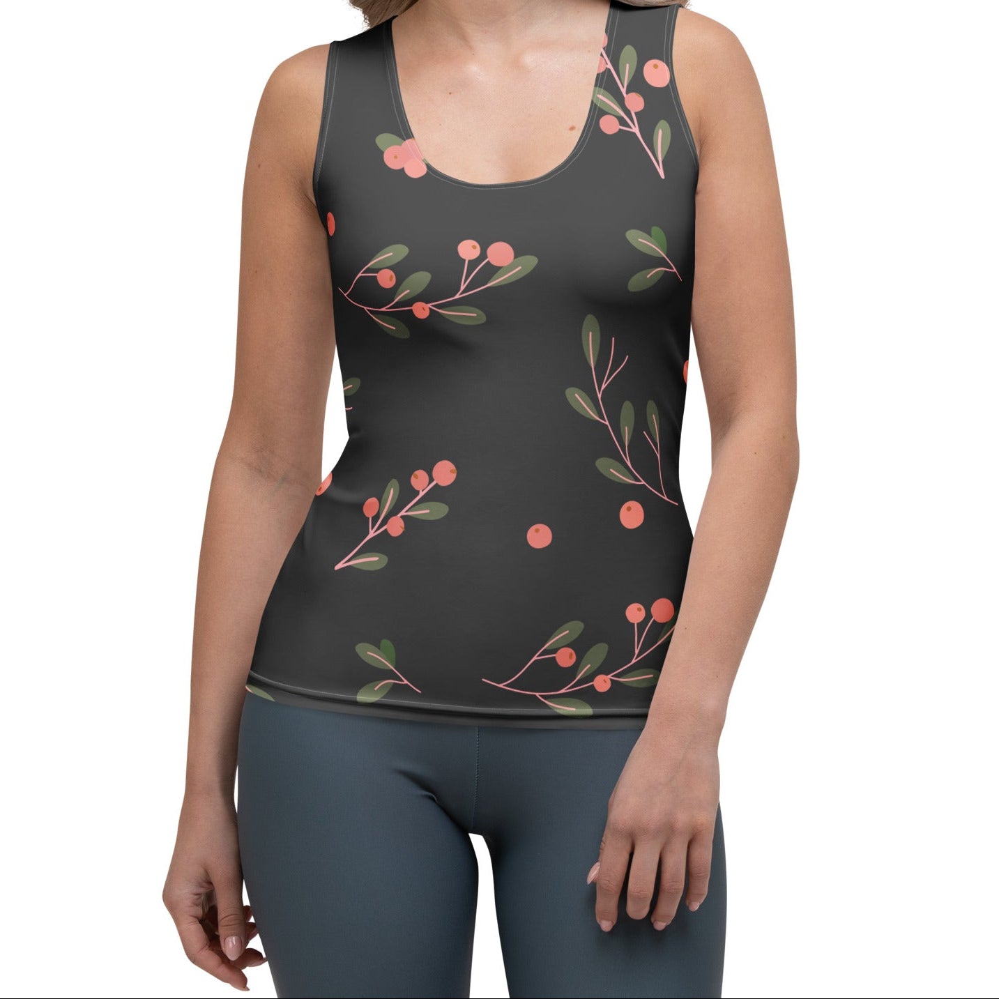 Woman wearing a brown sleeveless top with a decorative pink  design on a white background