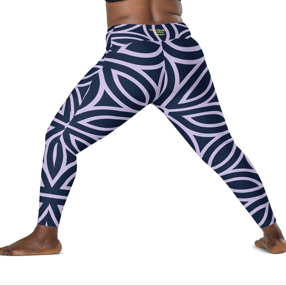 model wearing the Canary Wharf  Sculpt Crossover  Leggings in blue and lilac geometric floral pattern