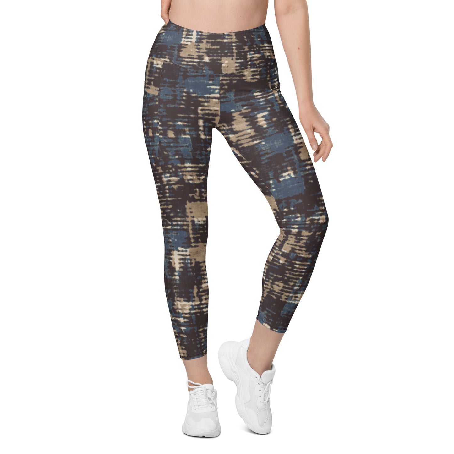 A model wearing the Chamonix Sculpt Leggings. A high-waisted leggings with an abstract brushstroke pattern in blue, beige, and dark brown, paired with white sneakers, shown against a plain white background.