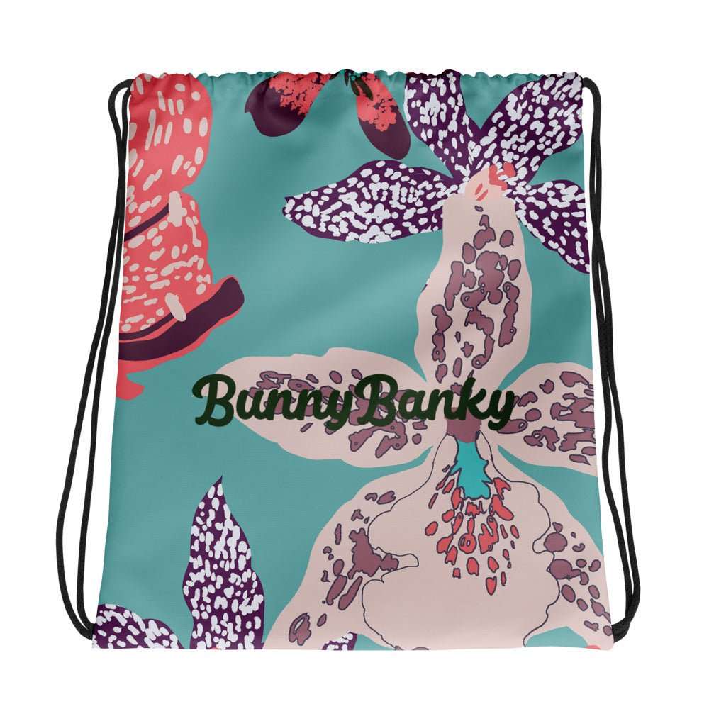 The Chelsea Drawstring Backpack featuring  a tropical print and  heritage logo against a white background.