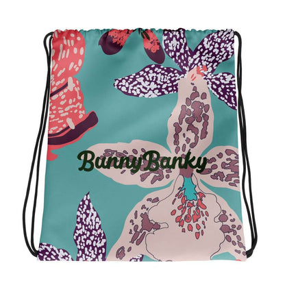 The Chelsea Drawstring Backpack featuring  a tropical print and  heritage logo against a white background.