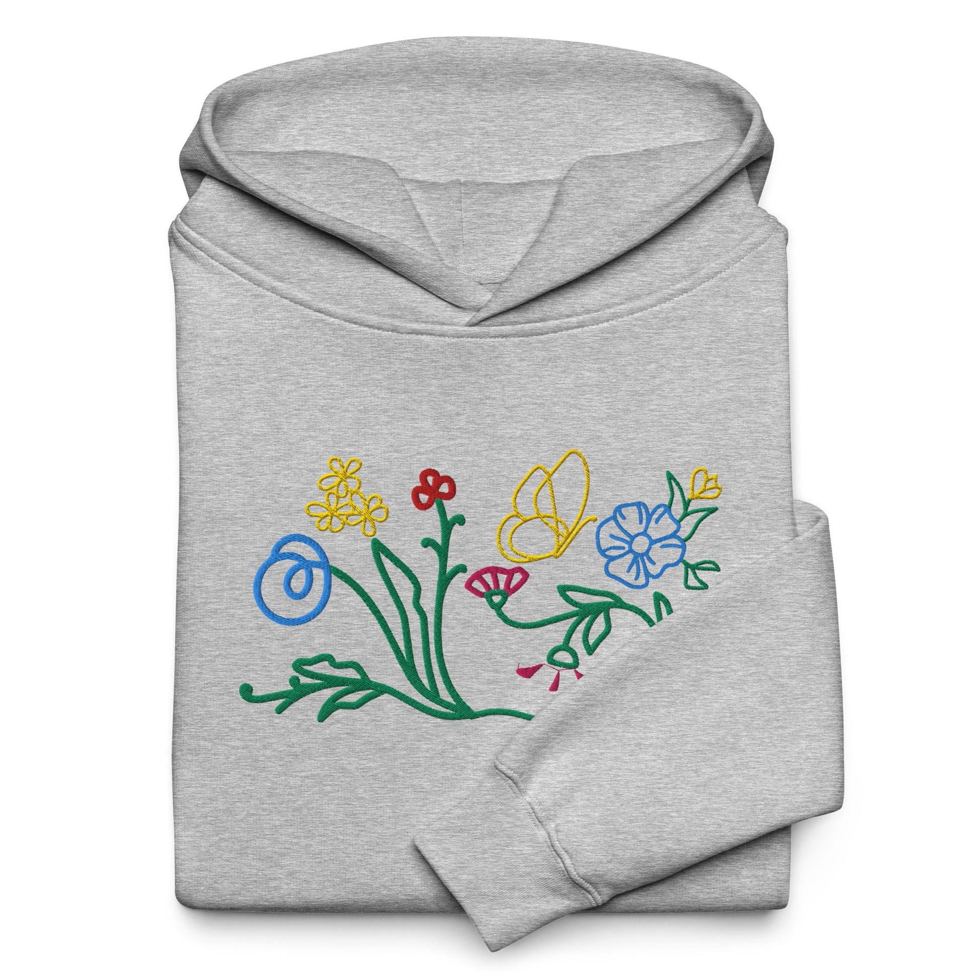A close-up of The Chelsea Garden Hoodie's front, highlighting the detailed, colorful floral embroidery and the soft brushed-fleece fabric.