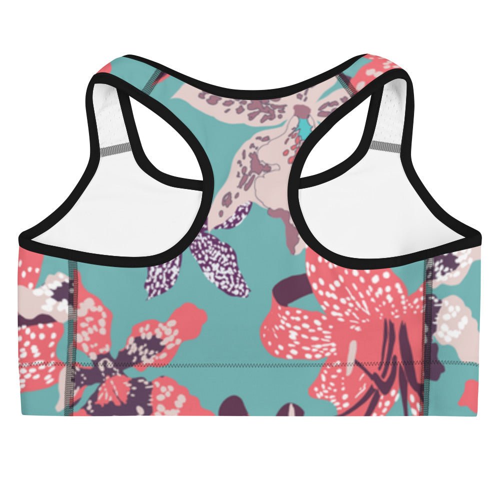 The Chelsea Performance Bra high-compression performance sports bra featuring a vibrant tropical floral print in turquoise and pink.