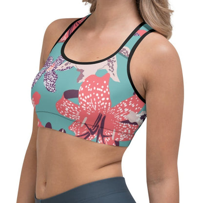 Model wearing the Chelsea Performance Bra featuring  a tropical print and racer back against a white background.