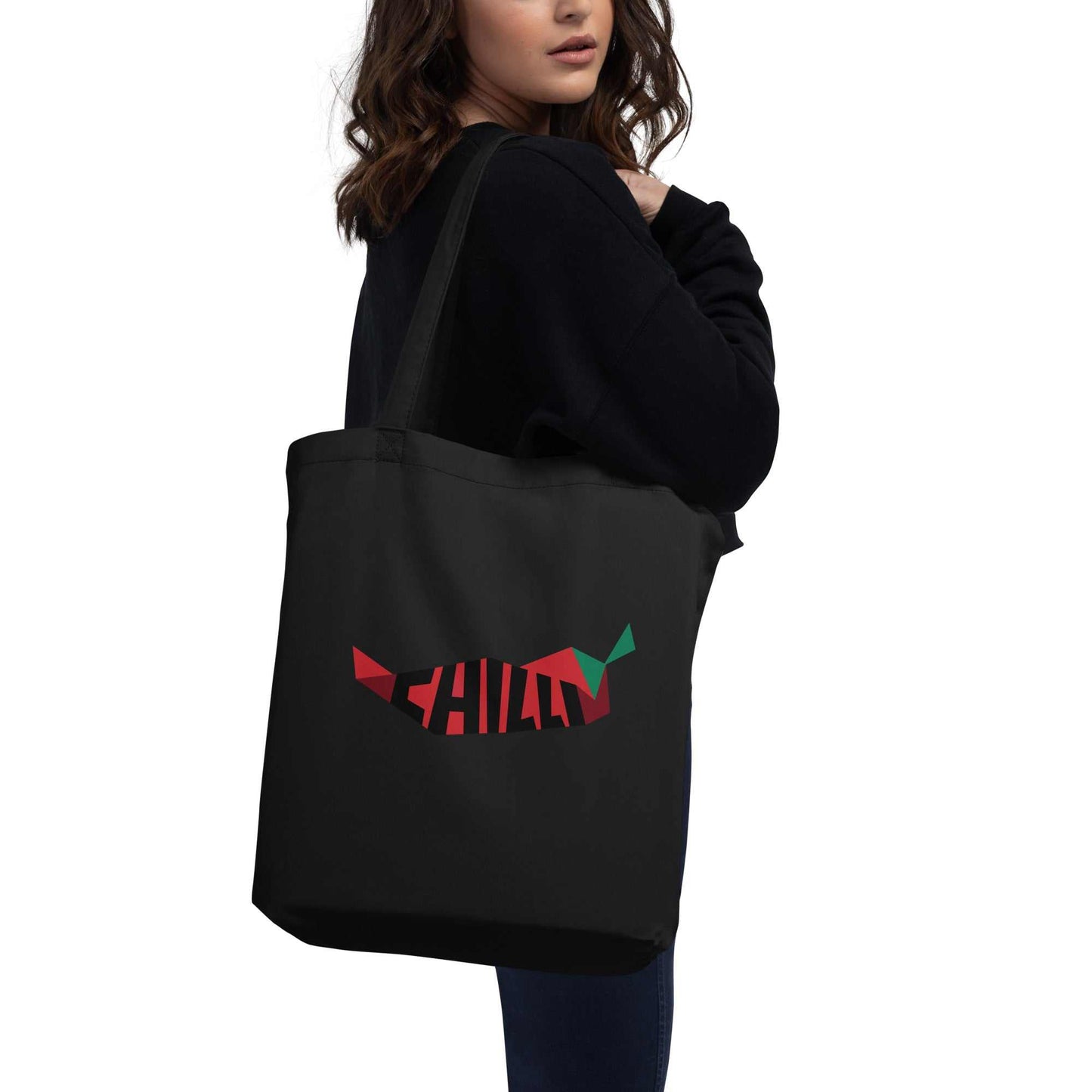 A model holding The Chilly Tote featuring a large red chili pepper and "Chilly" text on both sides.