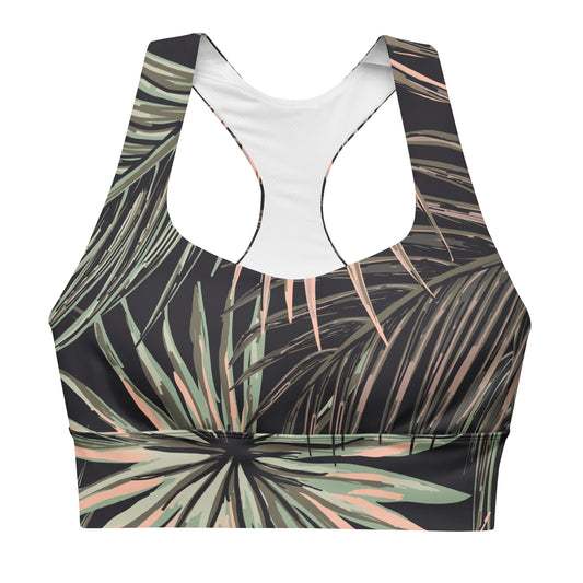 The Chiswick Longline Performance Bra. A racerback sports bra with a tropical palm leaf print on a black background, featuring sage green and dusty pink leaves, shown against a plain white background.