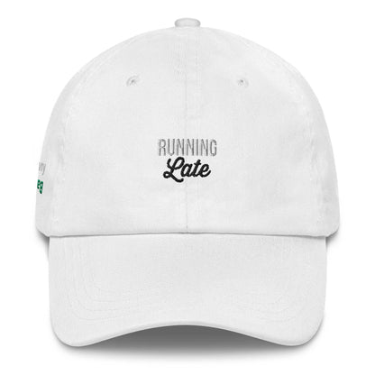 A close up of The Running Late Cap in pink showing the running late text embroidered in white and black