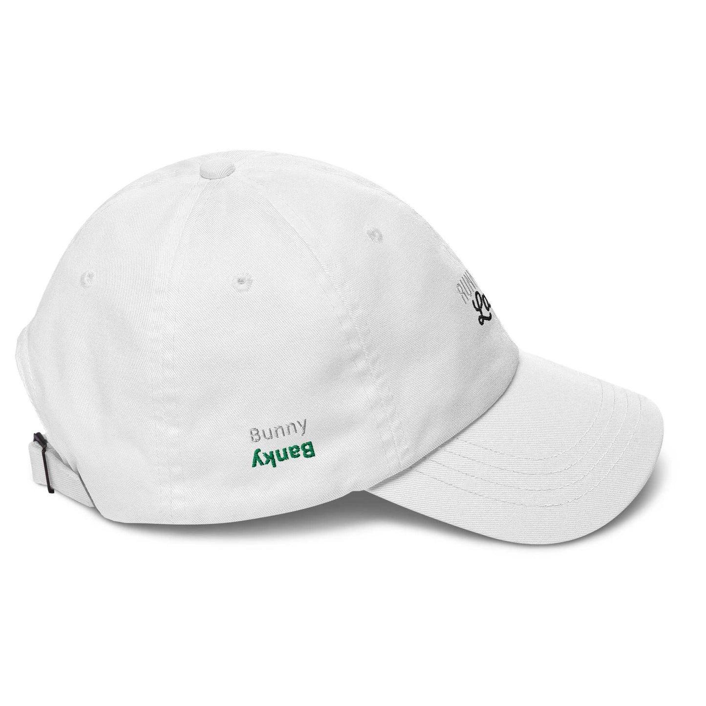 A close up of The Running Late Cap in pink showing the running late text embroidered in white and black