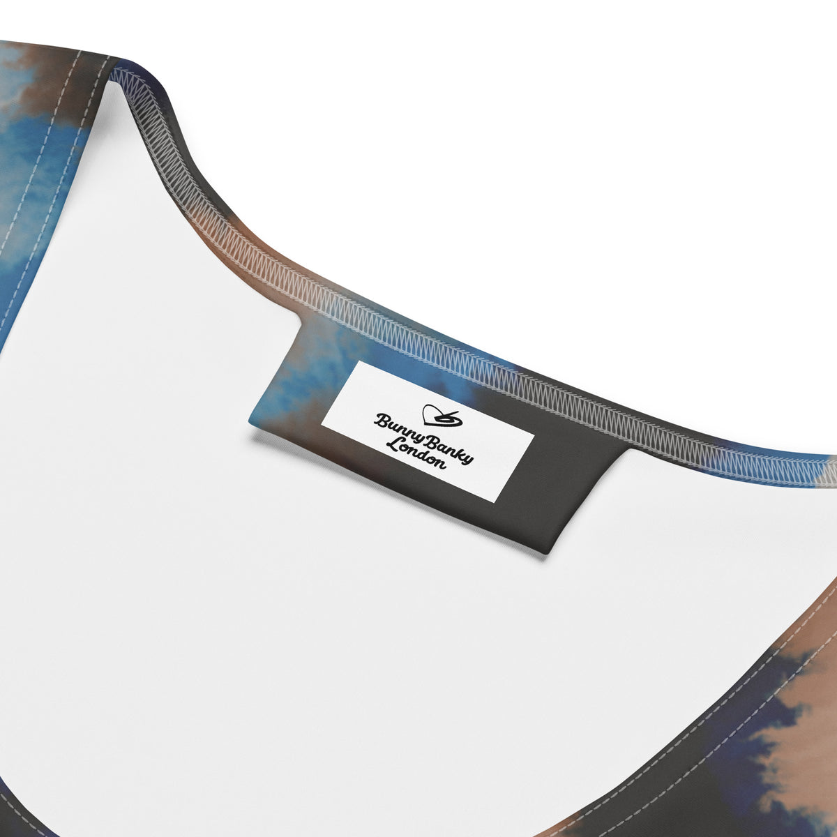Close-up of the smooth microfiber four-way stretch fabric and precision hand-sewn seams on the Côte d'Azur tank top.