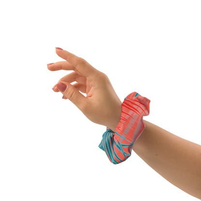disrtrict tropic scrunchie with a removable bow made from certified recycled polyester in vibrant tropic print in orange and turquoise hues