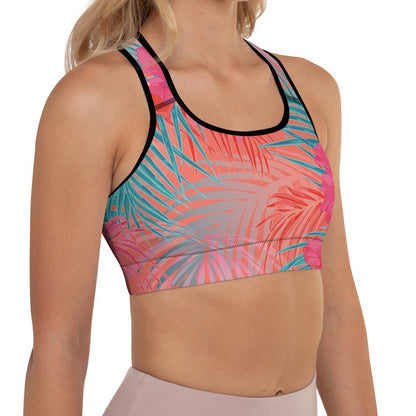 Close-up of a  model wearing the District Tropics Performance Bra. The image showcases the vibrant pink and blue floral pattern, the supportive racerback design, and the premium mesh lining details.