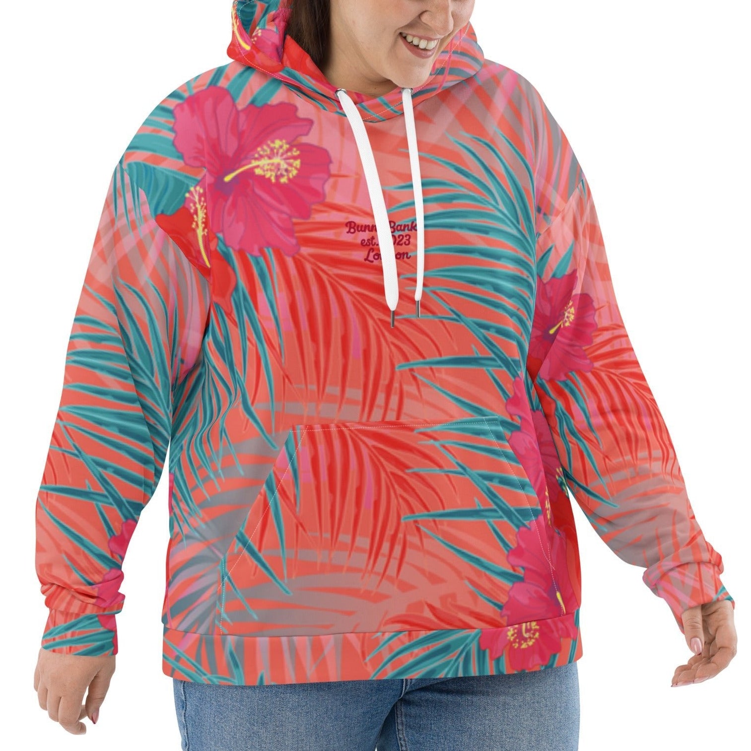 Model wearing the BunnyBankY District hoodie highlighting the vibrant pink , orange, and blue colours in a tropical floral print