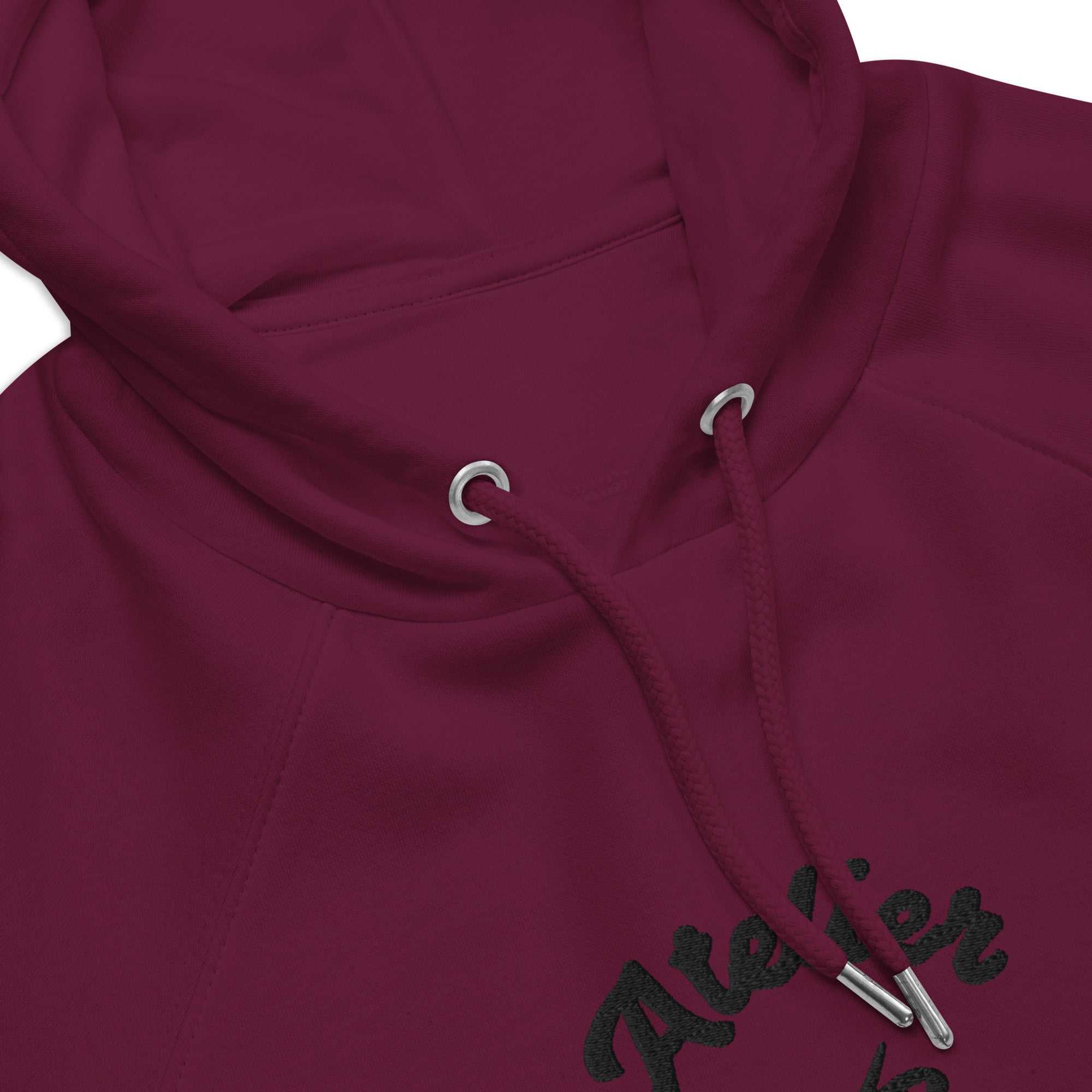 A close up of The Atelier Hoodie showing the branded atelier heart logo