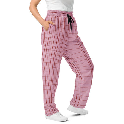 A woman modeling the edinburgh flow  joggers with a black drawstring, paired with a white tank top and white sneakers, against a plain white background.