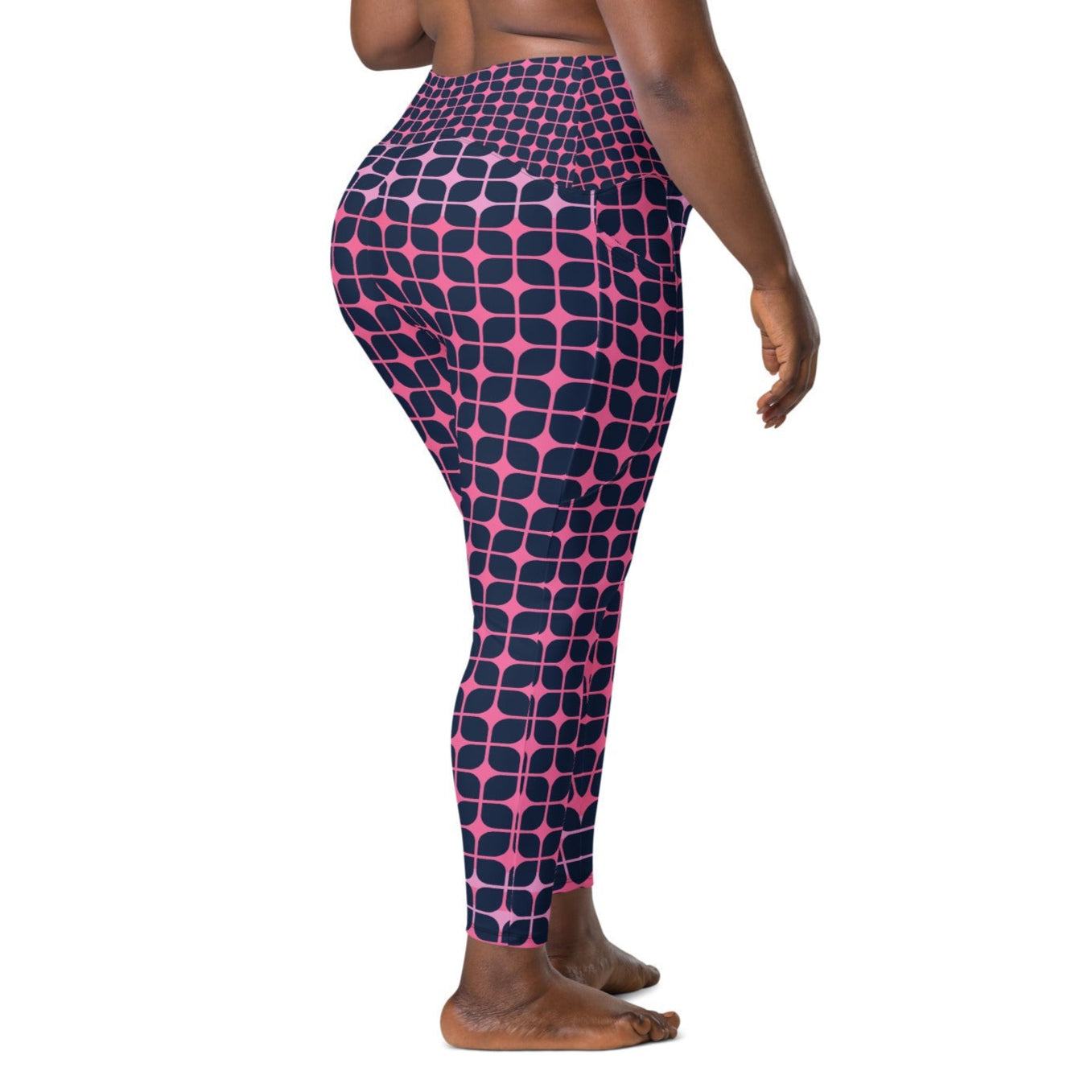 A model wearing The Embankment Sculpt Leggings, showing the sculpting fit and the navy and fuchsia geometric print.