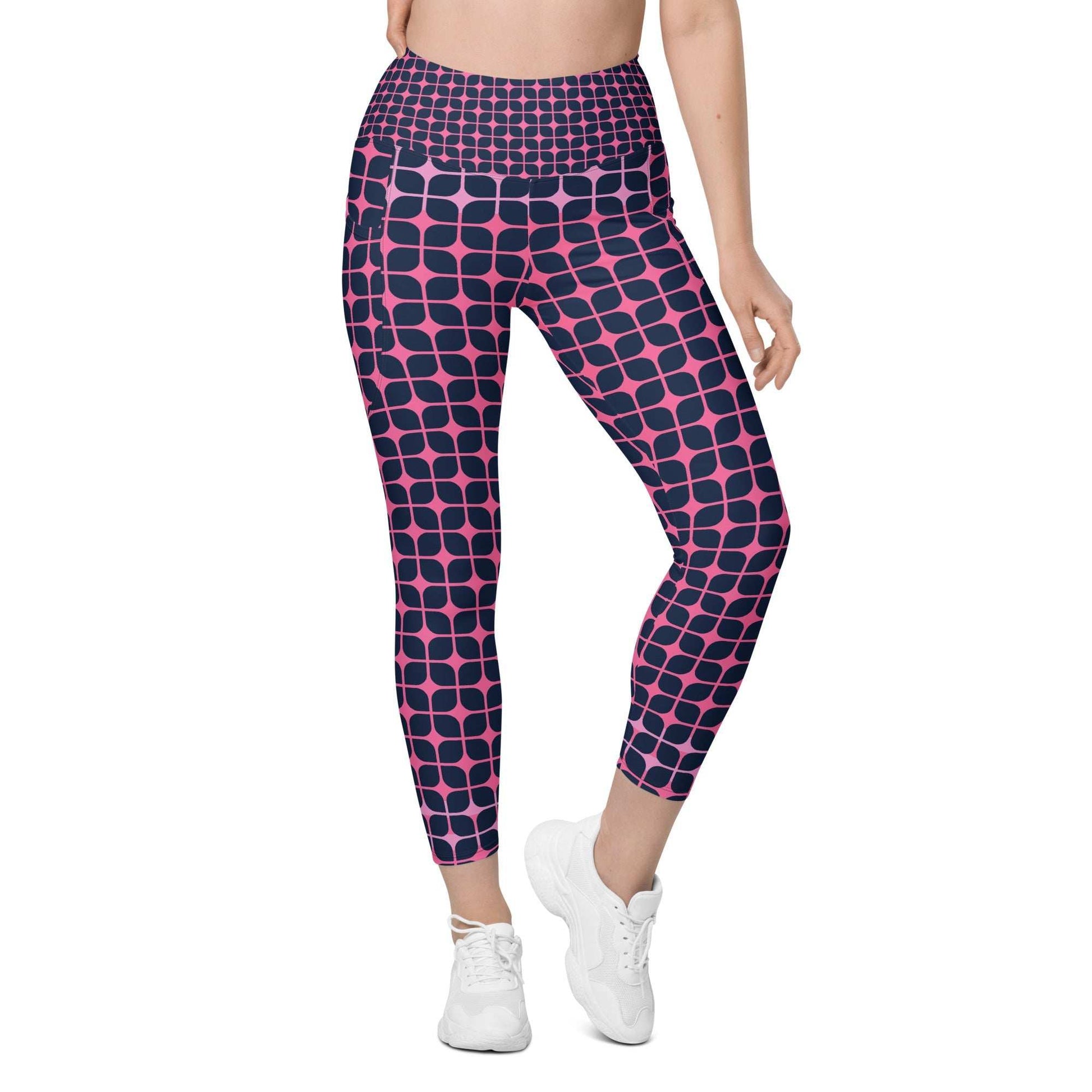 A model wearing The Embankment Sculpt Leggings, showing the sculpting fit and the navy and fuchsia geometric print.