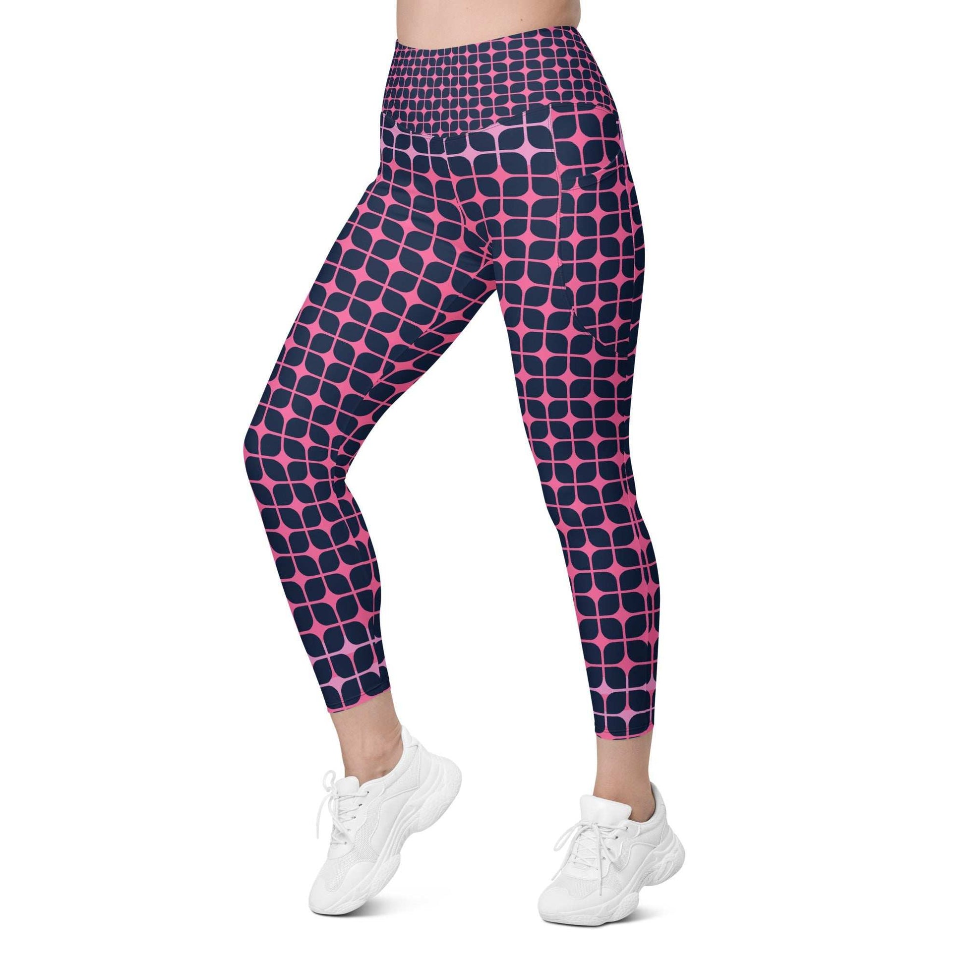 A model wearing The Embankment Sculpt Leggings, showing the sculpting fit and the navy and fuchsia geometric print.