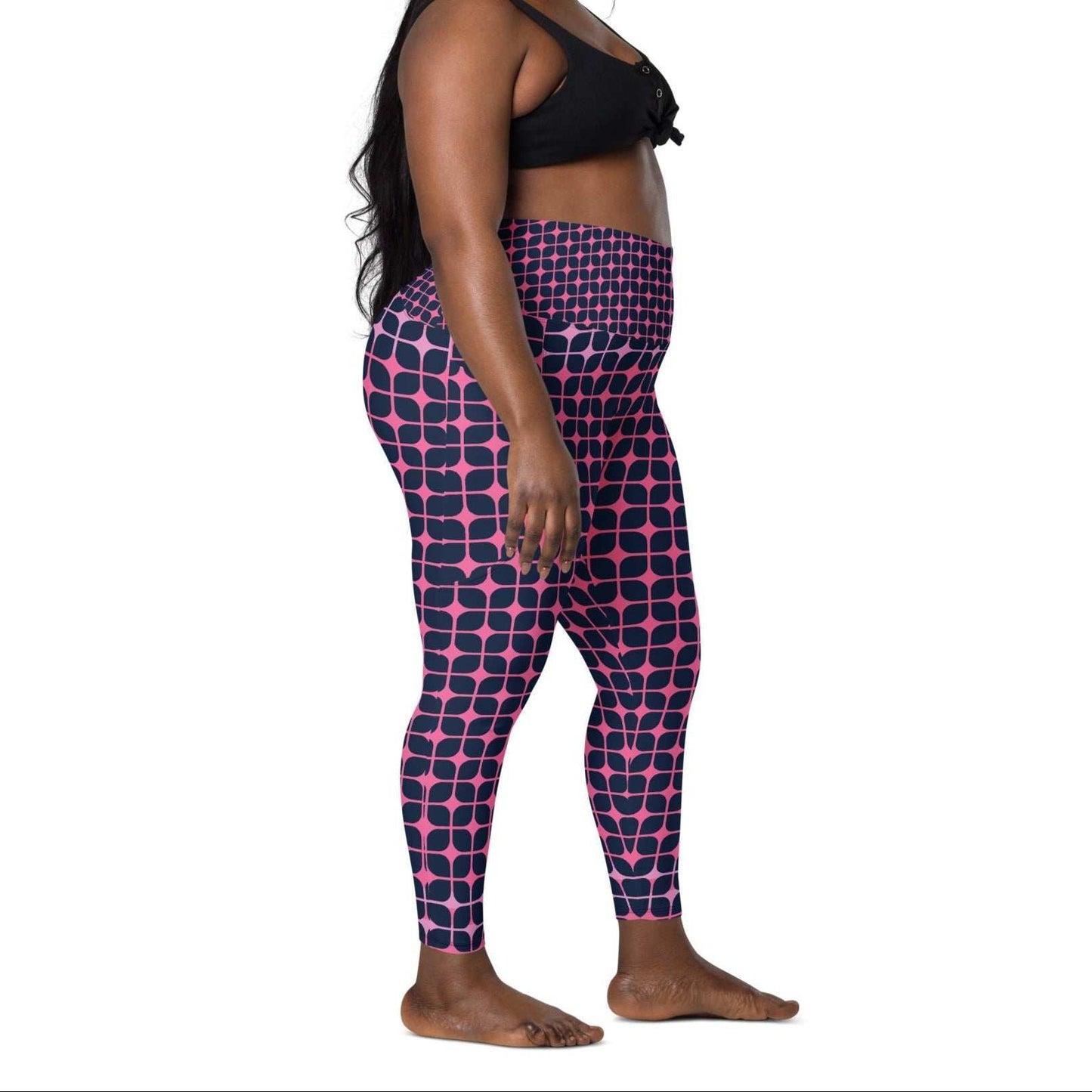 A model wearing The Embankment Sculpt Leggings, showing the sculpting fit and the navy and fuchsia geometric print.