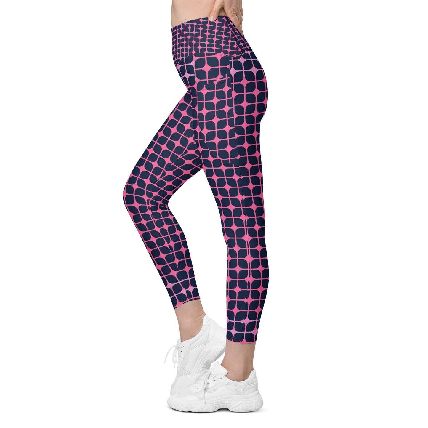 A model wearing The Embankment Sculpt Leggings, showing the sculpting fit and the navy and fuchsia geometric print.