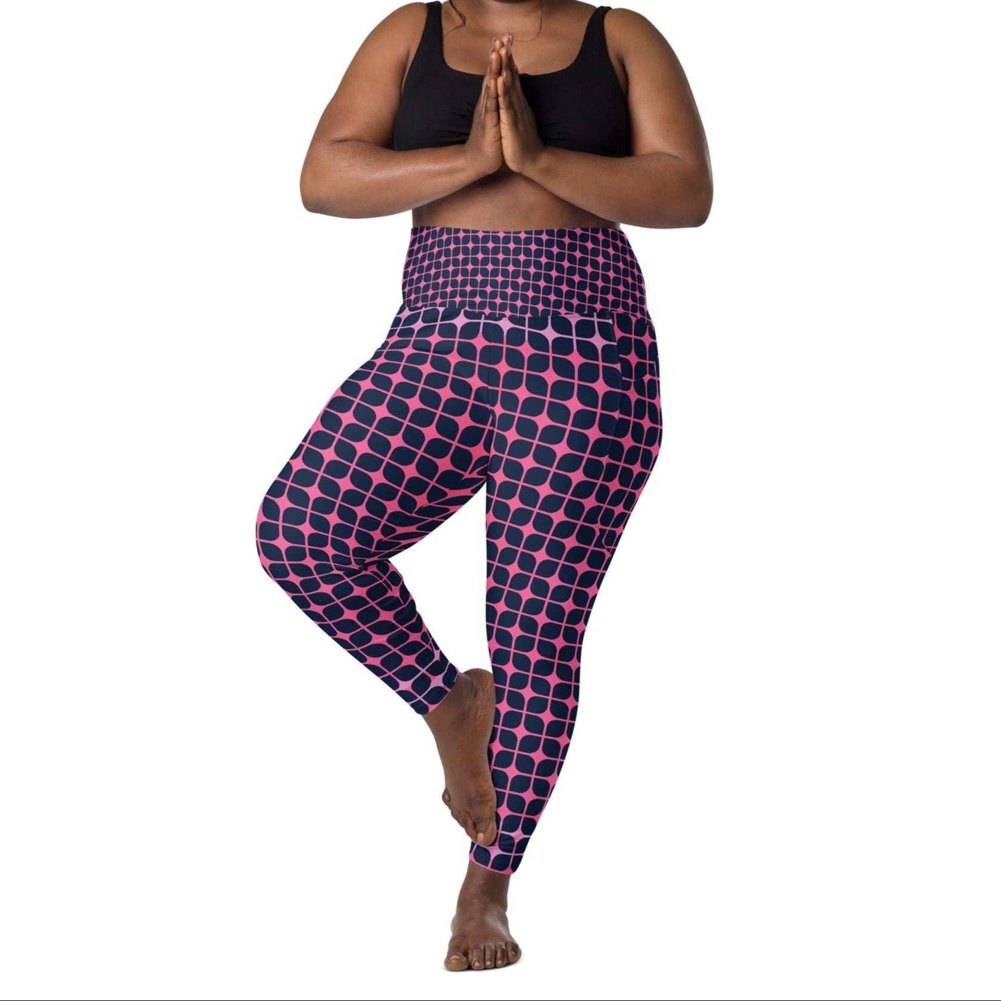 A model wearing The Embankment Sculpt Leggings, showing the sculpting fit and the navy and fuchsia geometric print.