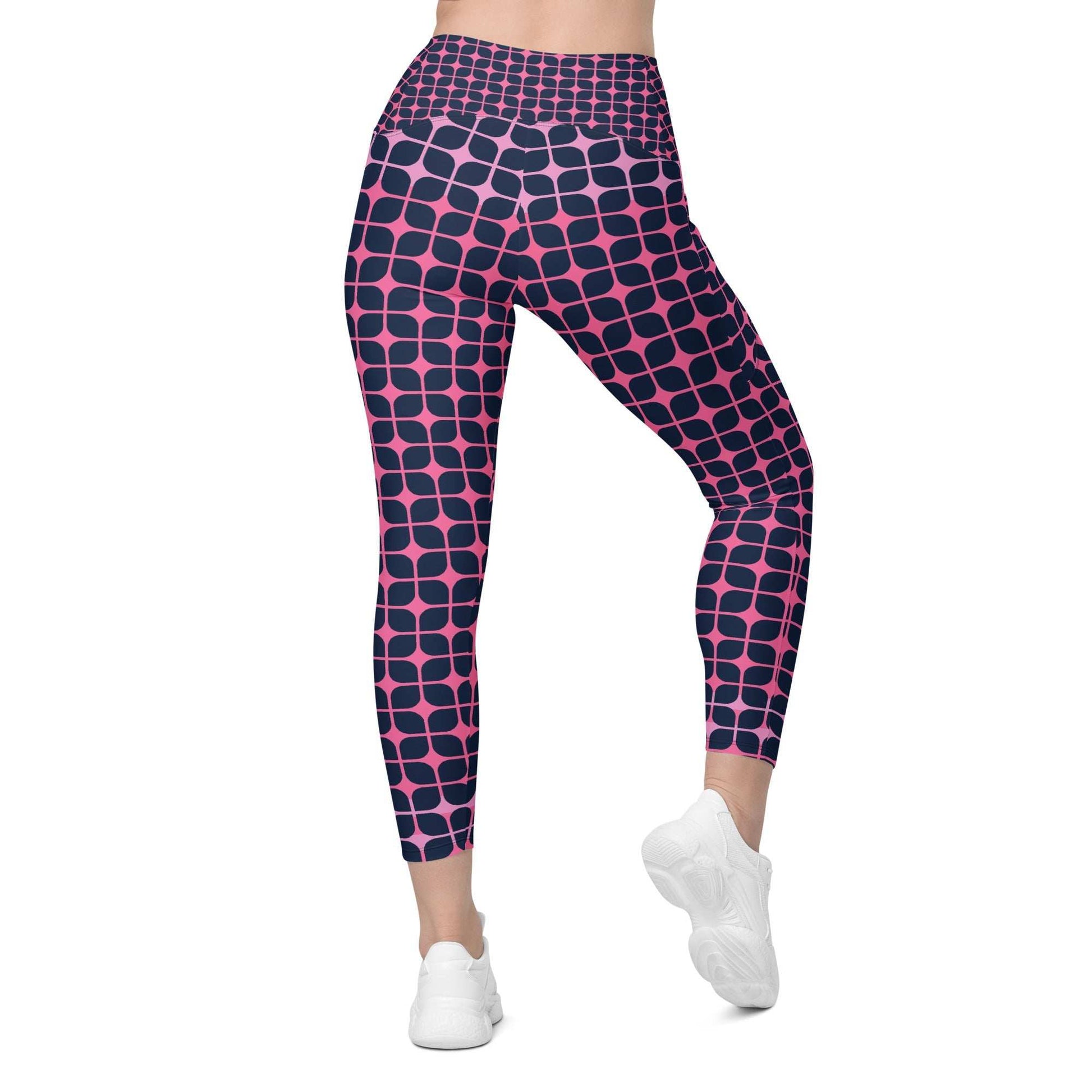 A model wearing The Embankment Sculpt Leggings, showing the sculpting fit and the navy and fuchsia geometric print.