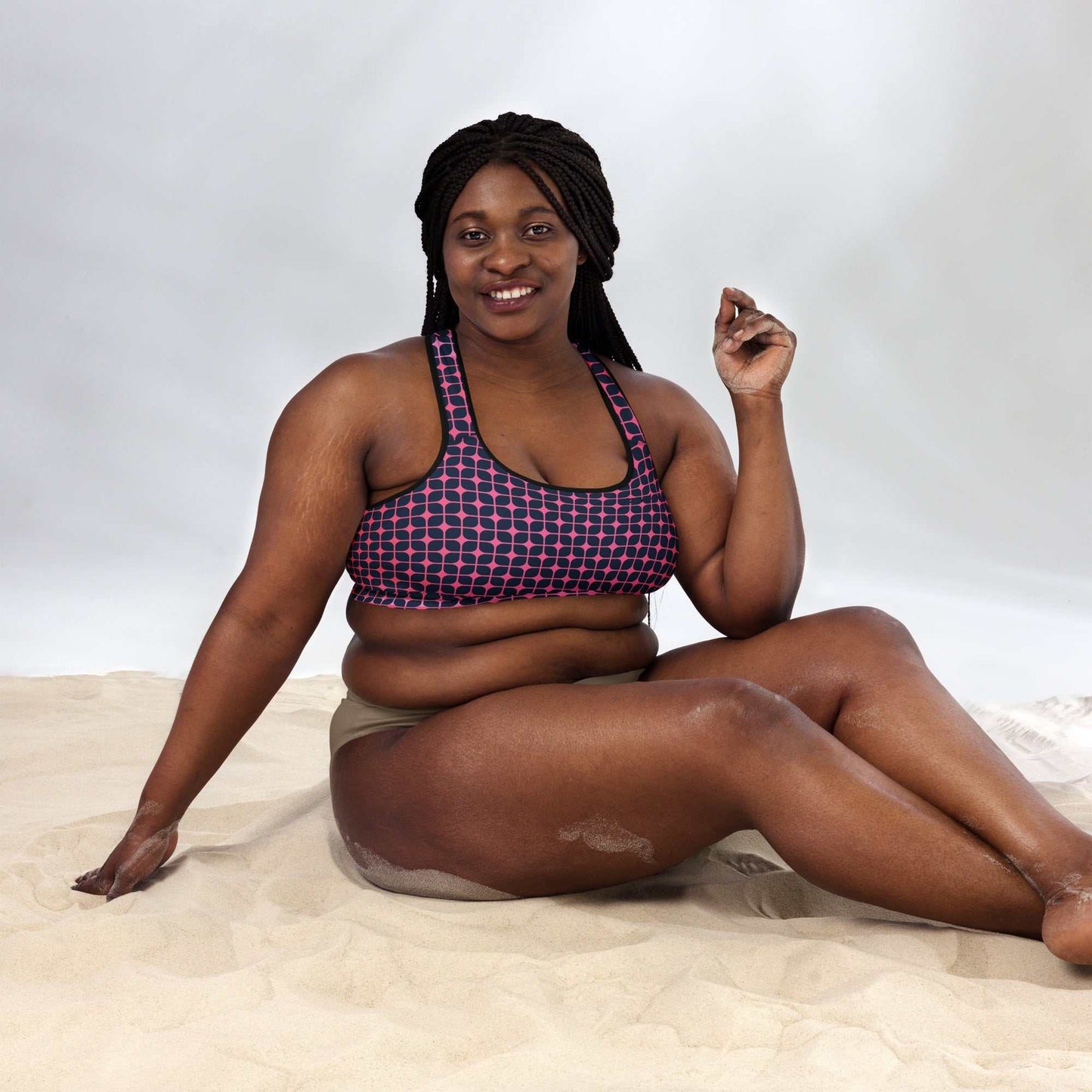 A model wearing The Embankment Performance Bra, showing the supportive fit and the navy and fuchsia geometric print.