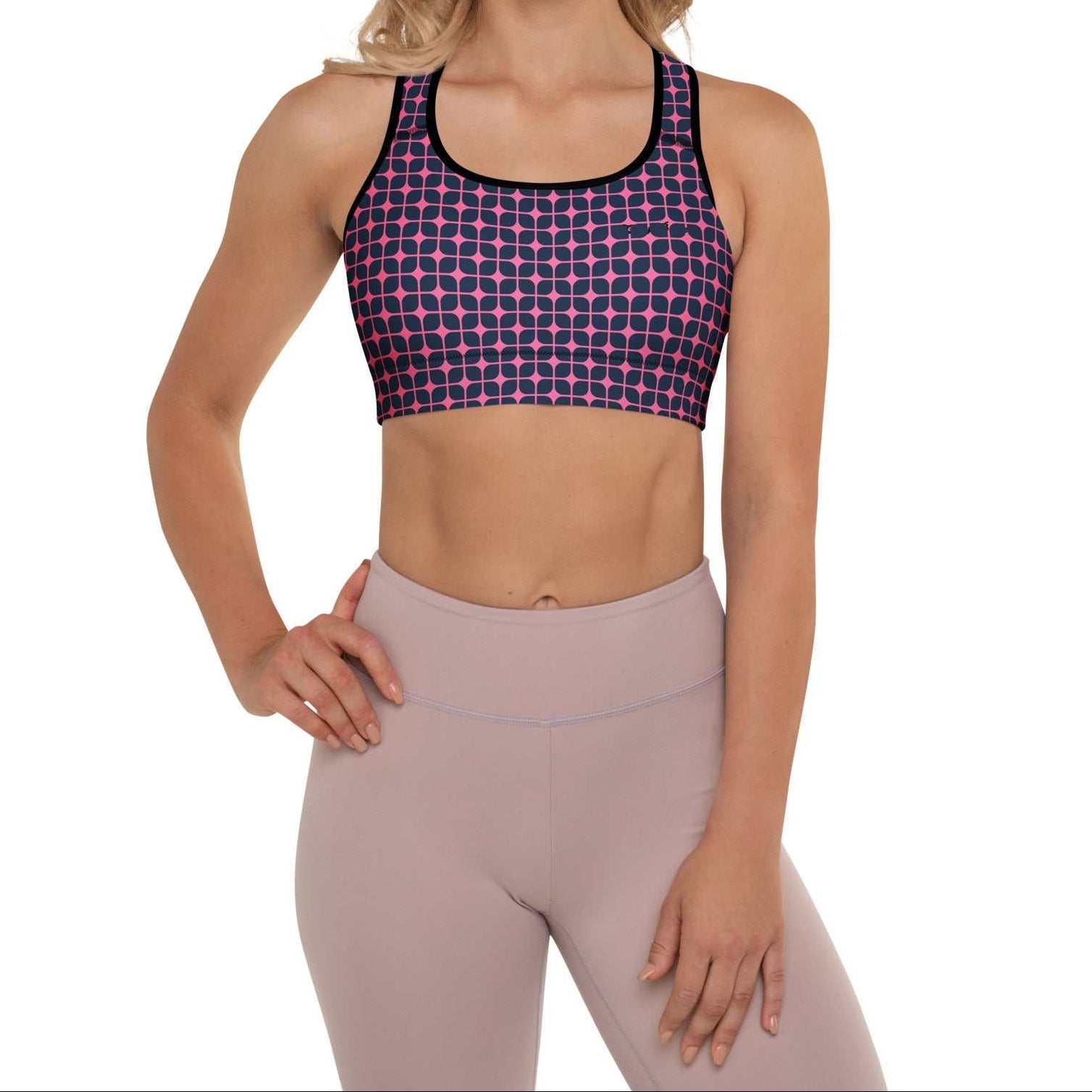 A model wearing The Embankment Performance Bra, showing the supportive fit and the navy and fuchsia geometric print.