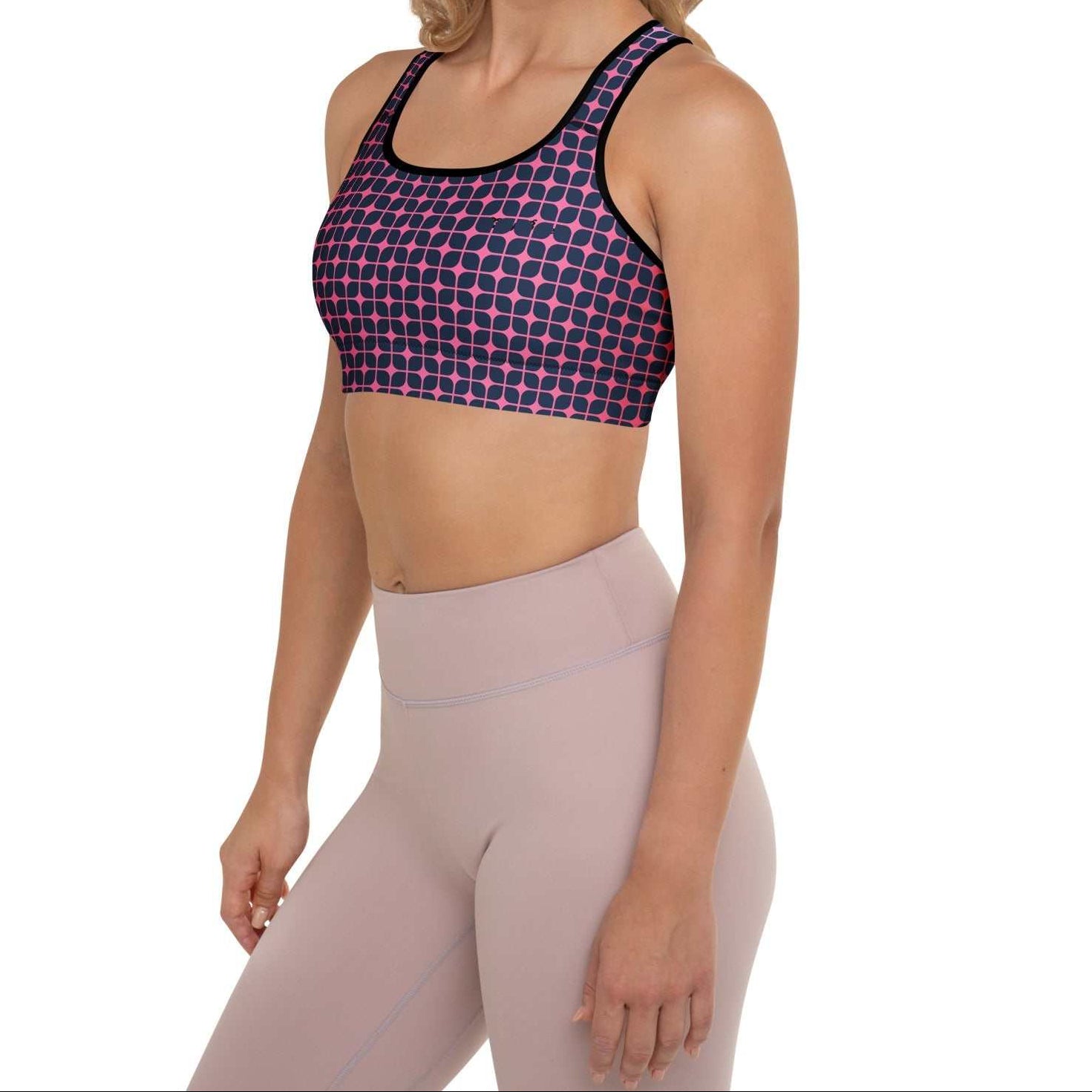 A model wearing The Embankment Performance Bra, showing the supportive fit and the navy and fuchsia geometric print.