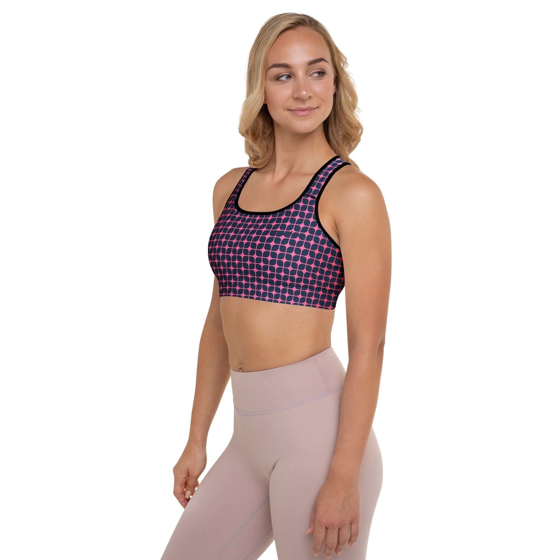 A model wearing The Embankment Performance Bra, showing the supportive fit and the navy and fuchsia geometric print.