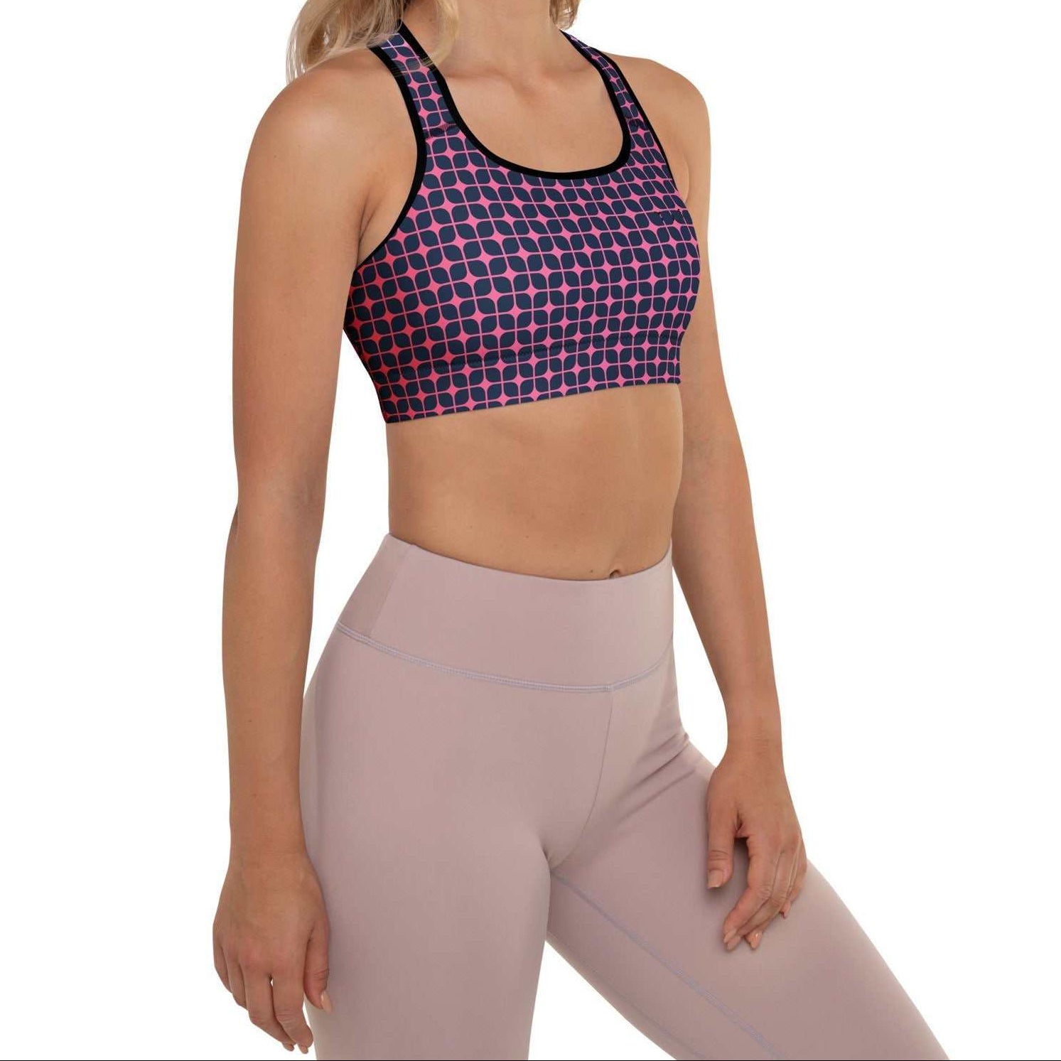 A model wearing The Embankment Performance Bra, showing the supportive fit and the navy and fuchsia geometric print.