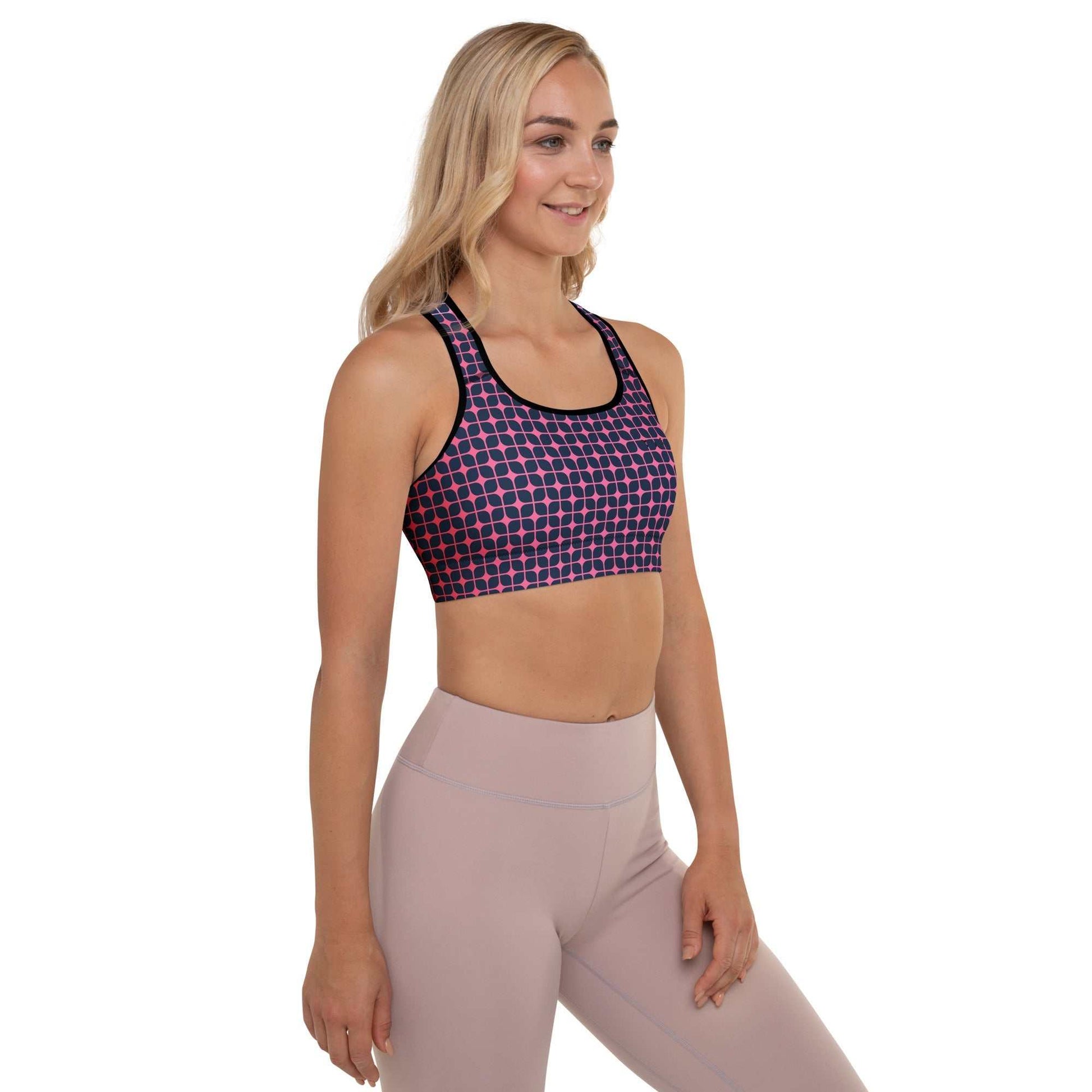 A model wearing The Embankment Performance Bra, showing the supportive fit and the navy and fuchsia geometric print.