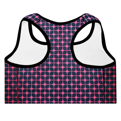 A close up of The Embankment Performance Bra, showing the supportive fit and the navy and fuchsia geometric print.