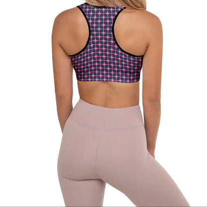 A model wearing The Embankment Performance Bra, showing the supportive fit and the navy and fuchsia geometric print.