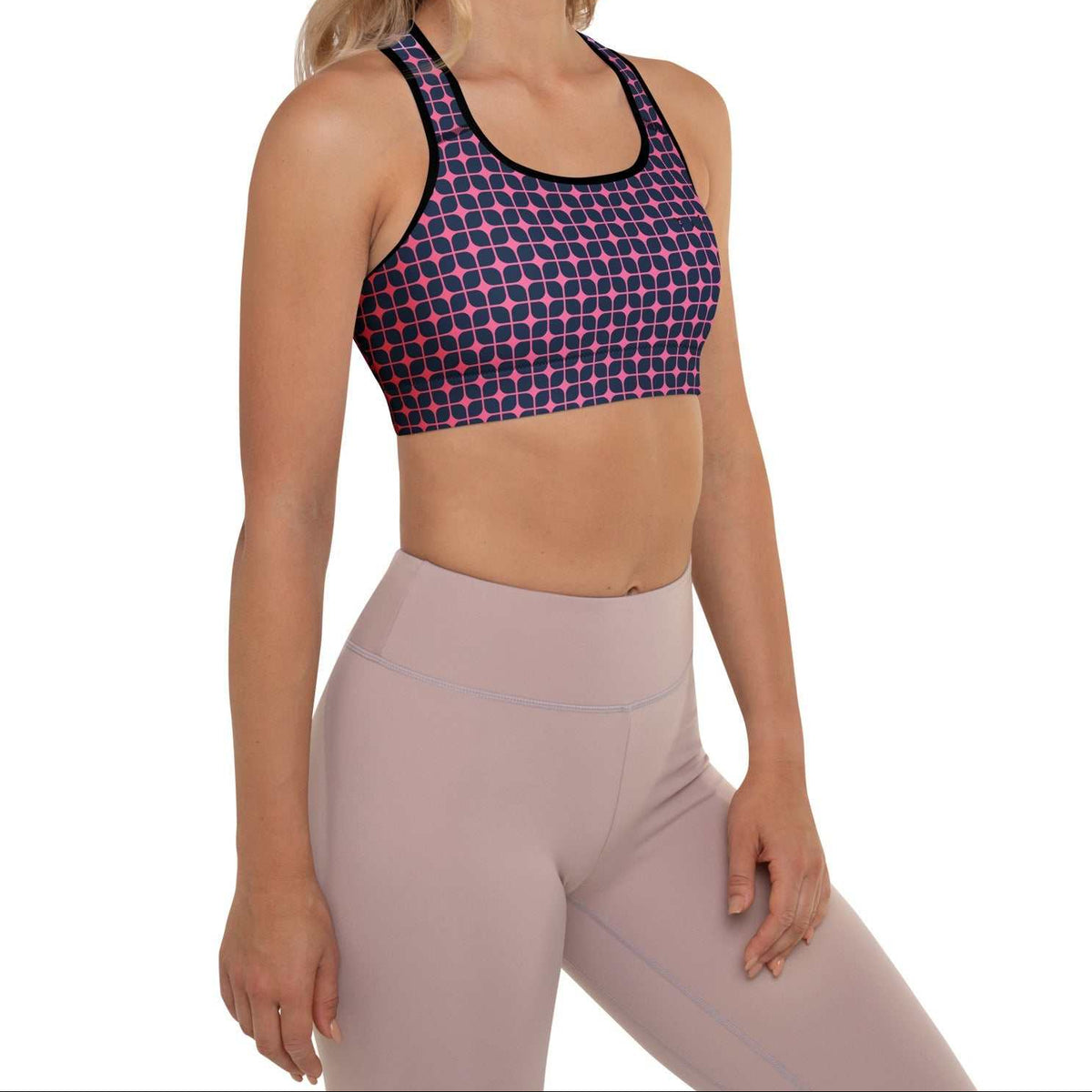A model wearing The Embankment Performance Bra, showing the supportive fit and the navy and fuchsia geometric print.