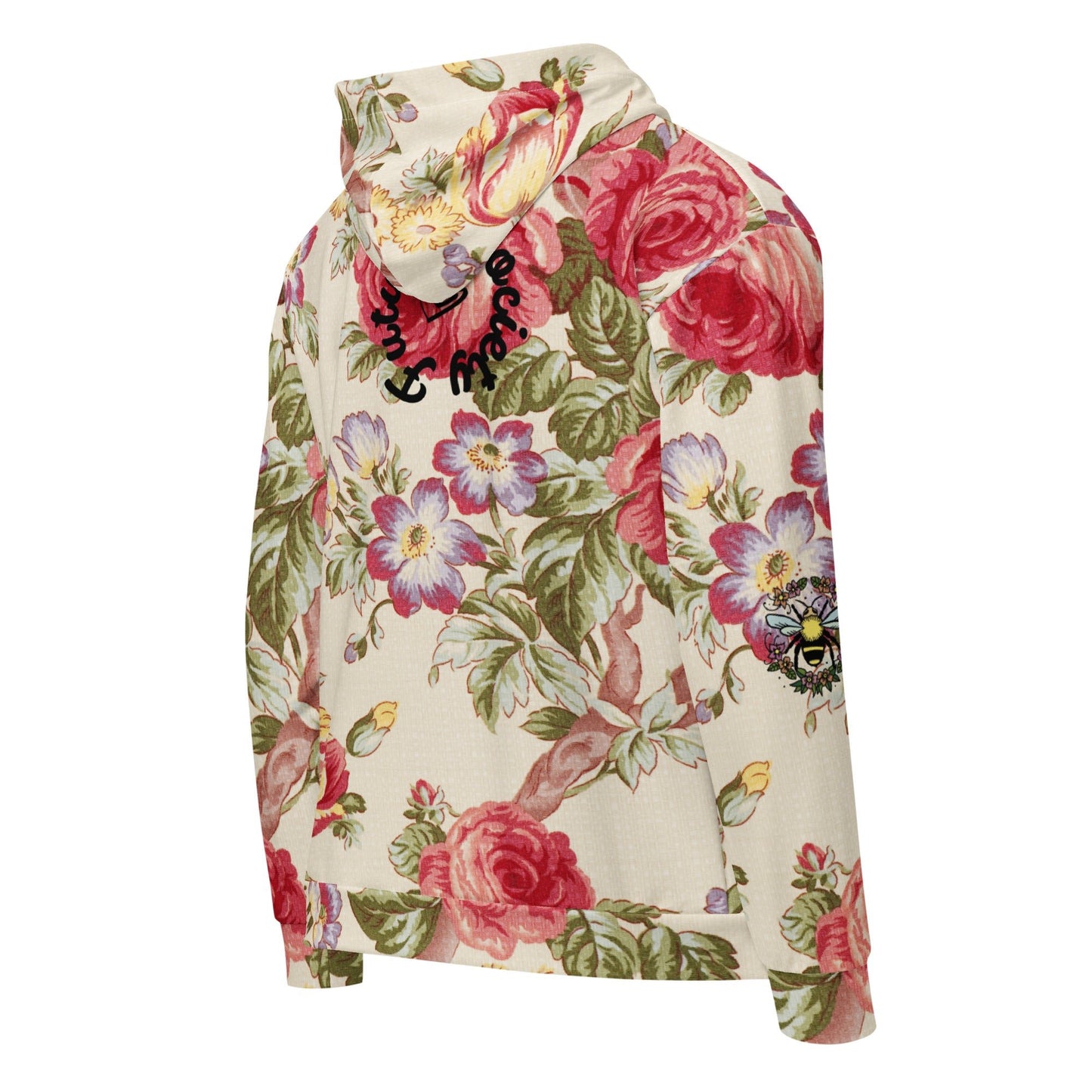 A close up of the Evergreen Zip Hoodie, showcasing the elaborate red rose and green vine vintage print on a sustainable cream fabric.