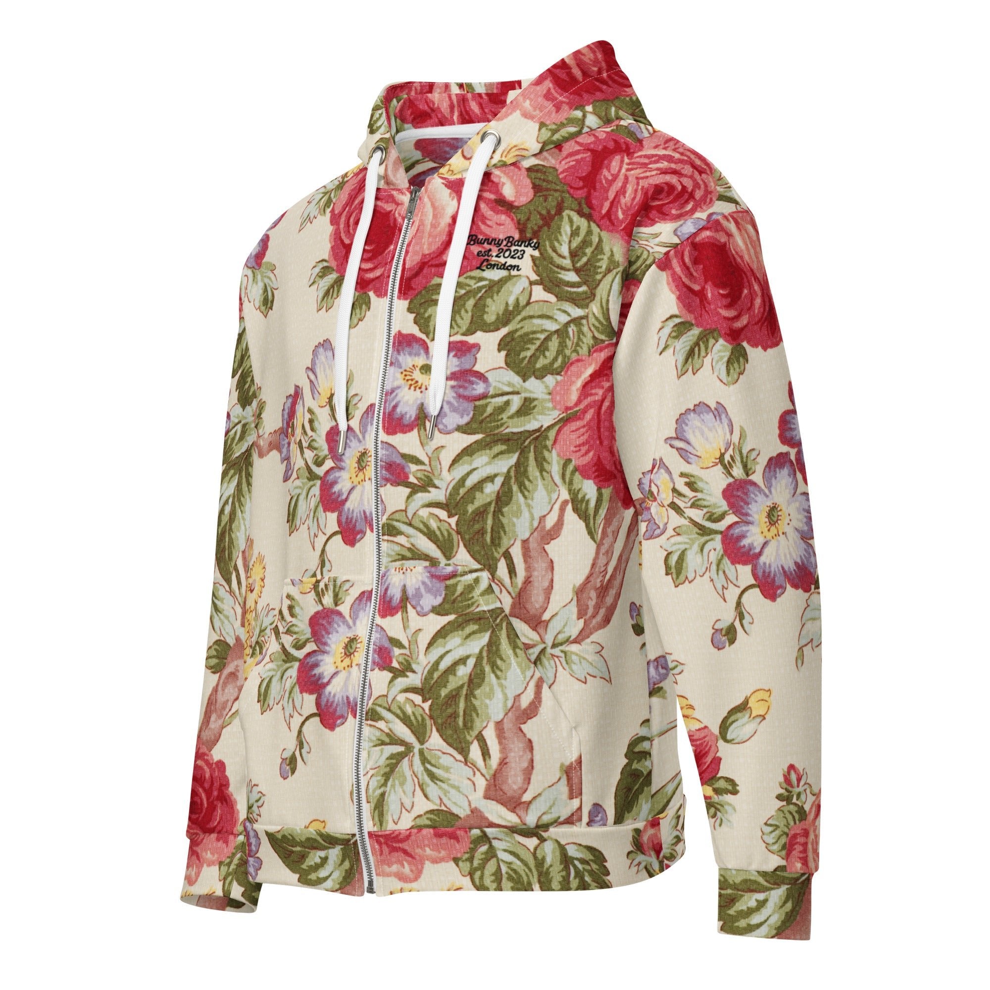 A close up of the Evergreen Zip Hoodie, showcasing the elaborate red rose and green vine vintage print on a sustainable cream fabric.