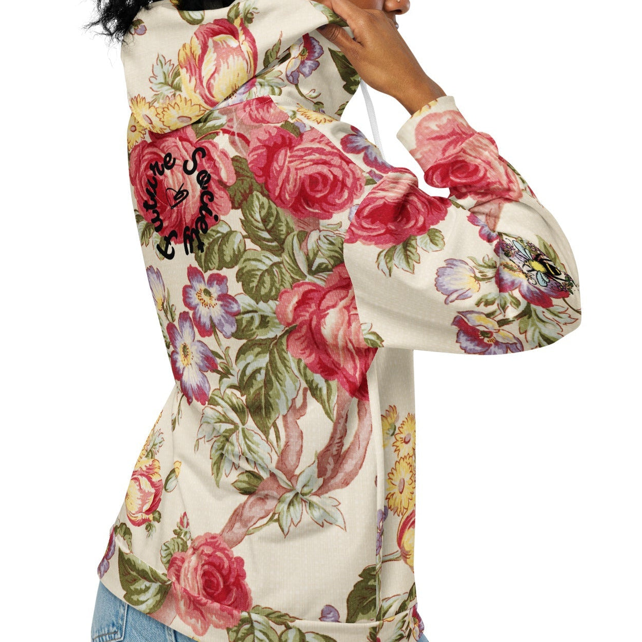 A model wearing the Evergreen Zip Hoodie, showcasing the elaborate red rose and green vine vintage print on a sustainable cream fabric.