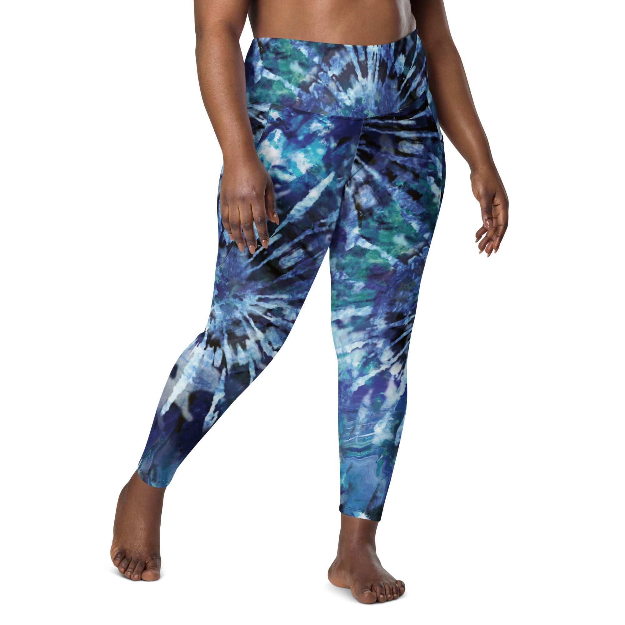 Blue and green tie-dye high-waisted leggings with side pockets and tight fit on model
