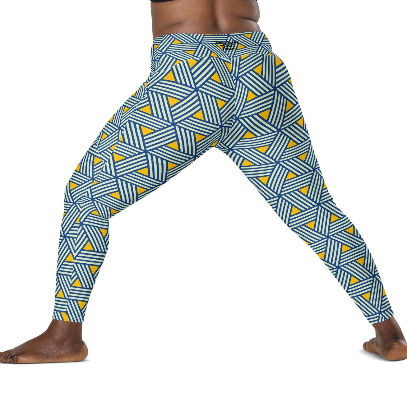 model wearing the Geneva Sculpt Leggings featuring a pattern of interweaved blue lines in yellow background.