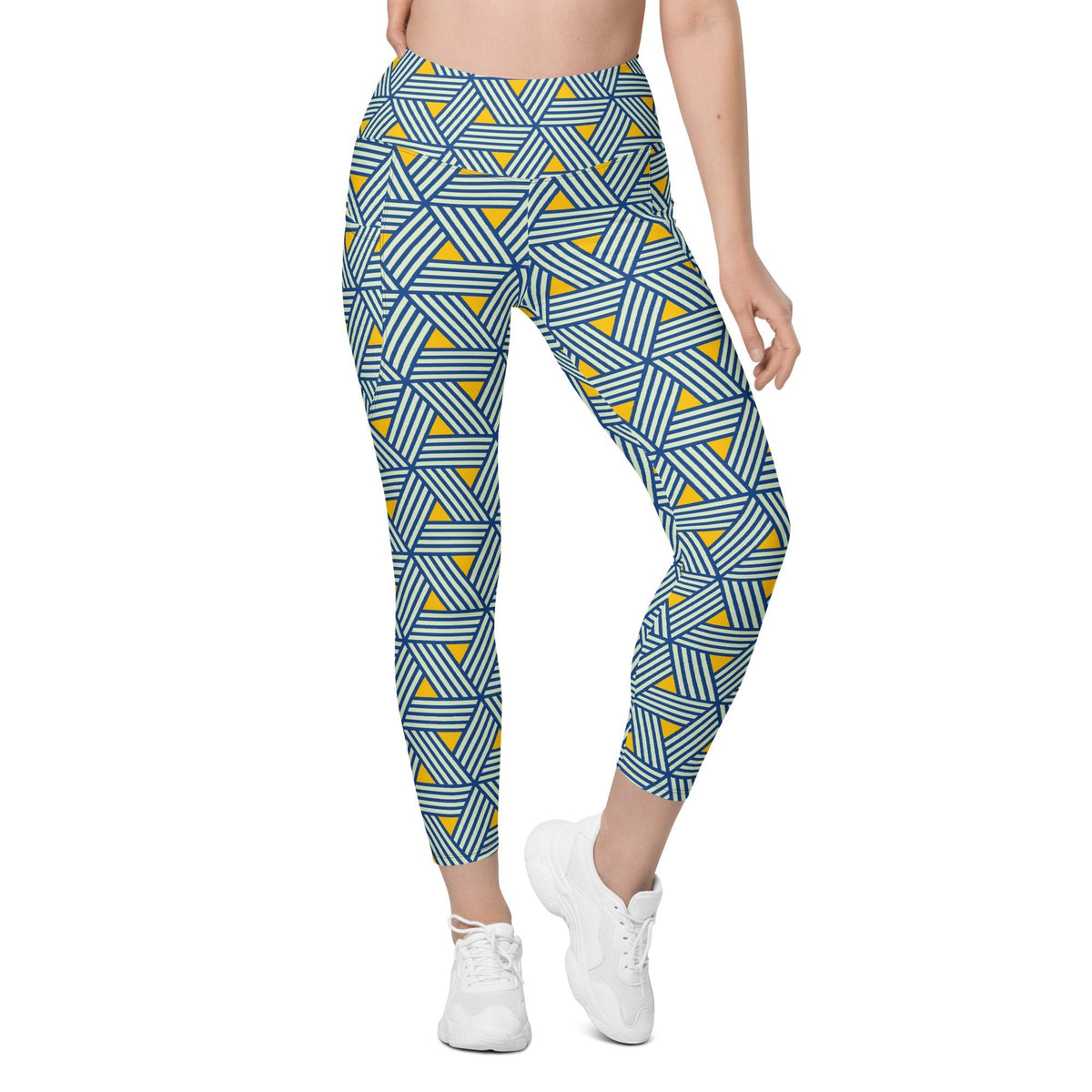 model wearing the Geneva Sculpt Leggings featuring a pattern of interweaved blue lines in yellow background.