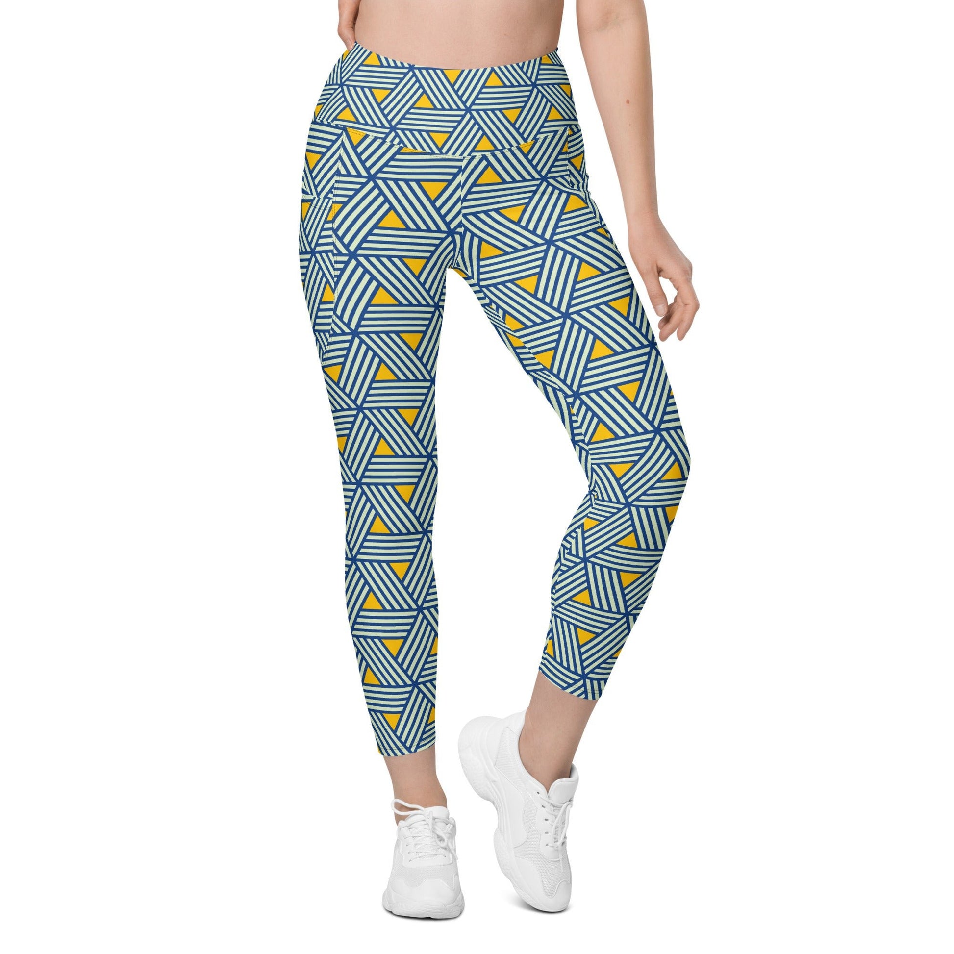 model wearing the Geneva Sculpt Leggings featuring a pattern of interweaved blue lines in yellow background.