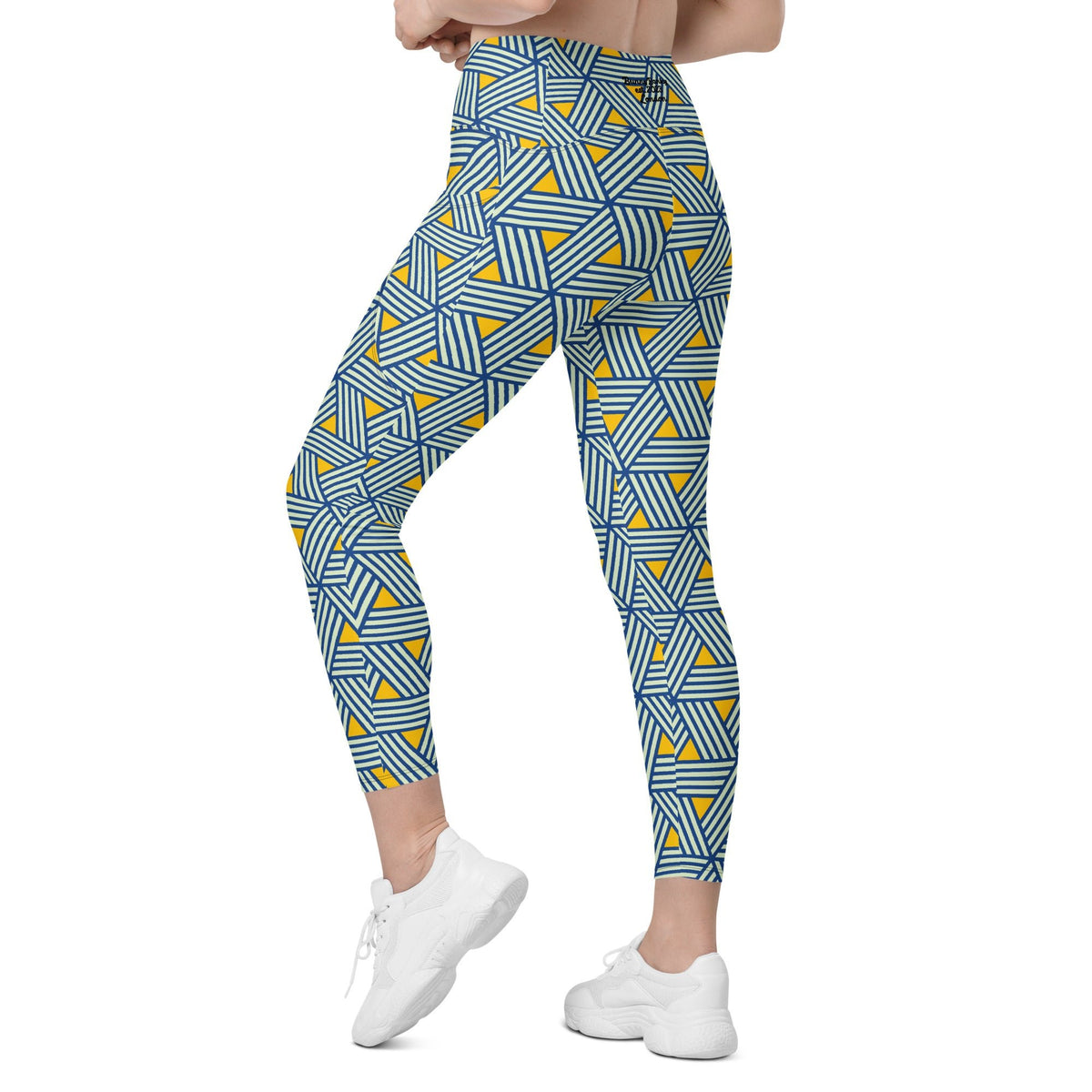 model wearing the Geneva Sculpt Leggings featuring a pattern of interweaved blue lines in yellow background.
