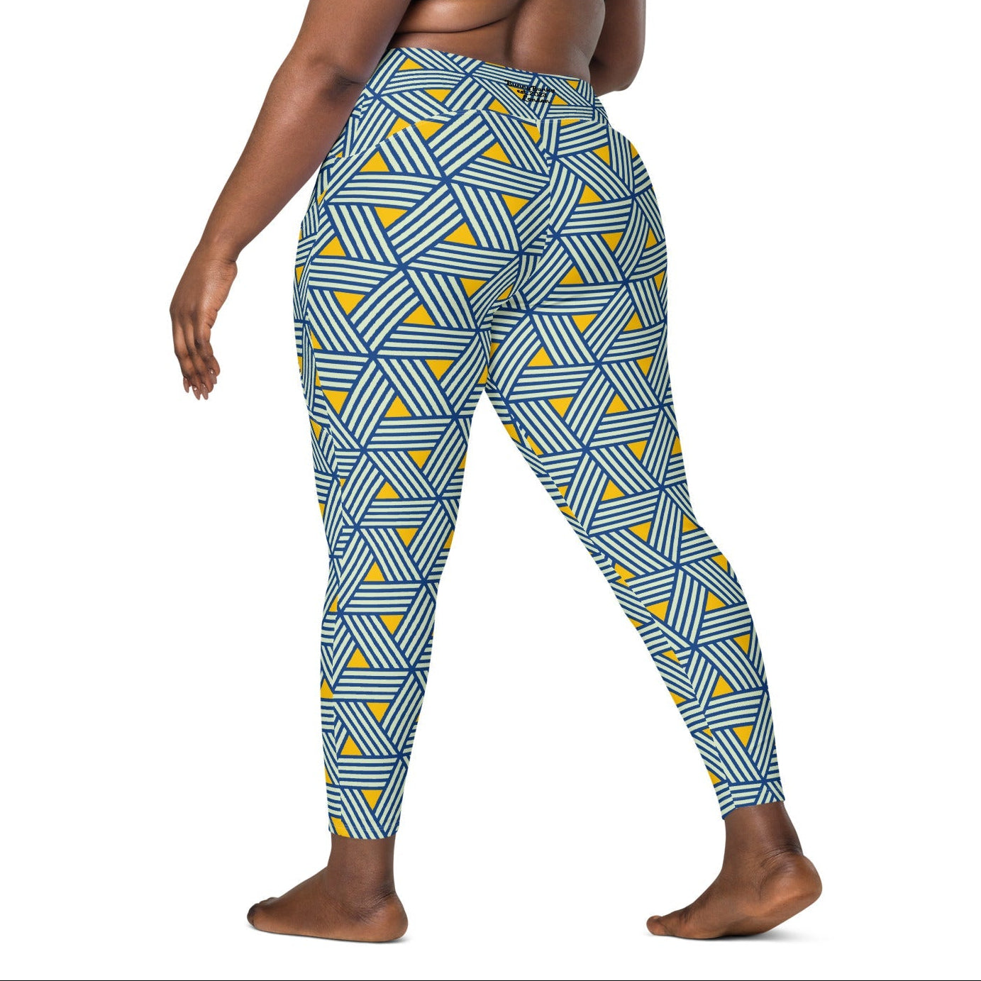model wearing the Geneva Sculpt Leggings featuring a pattern of interweaved blue lines in yellow background.