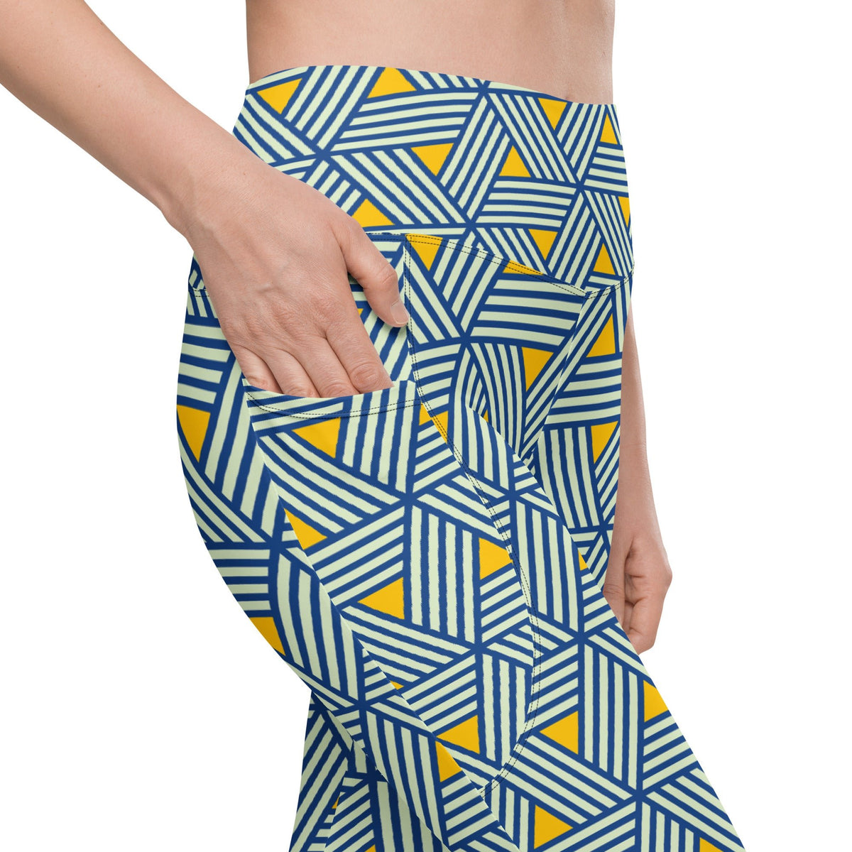 model wearing the Geneva Sculpt Leggings featuring a pattern of interweaved blue lines in yellow background.