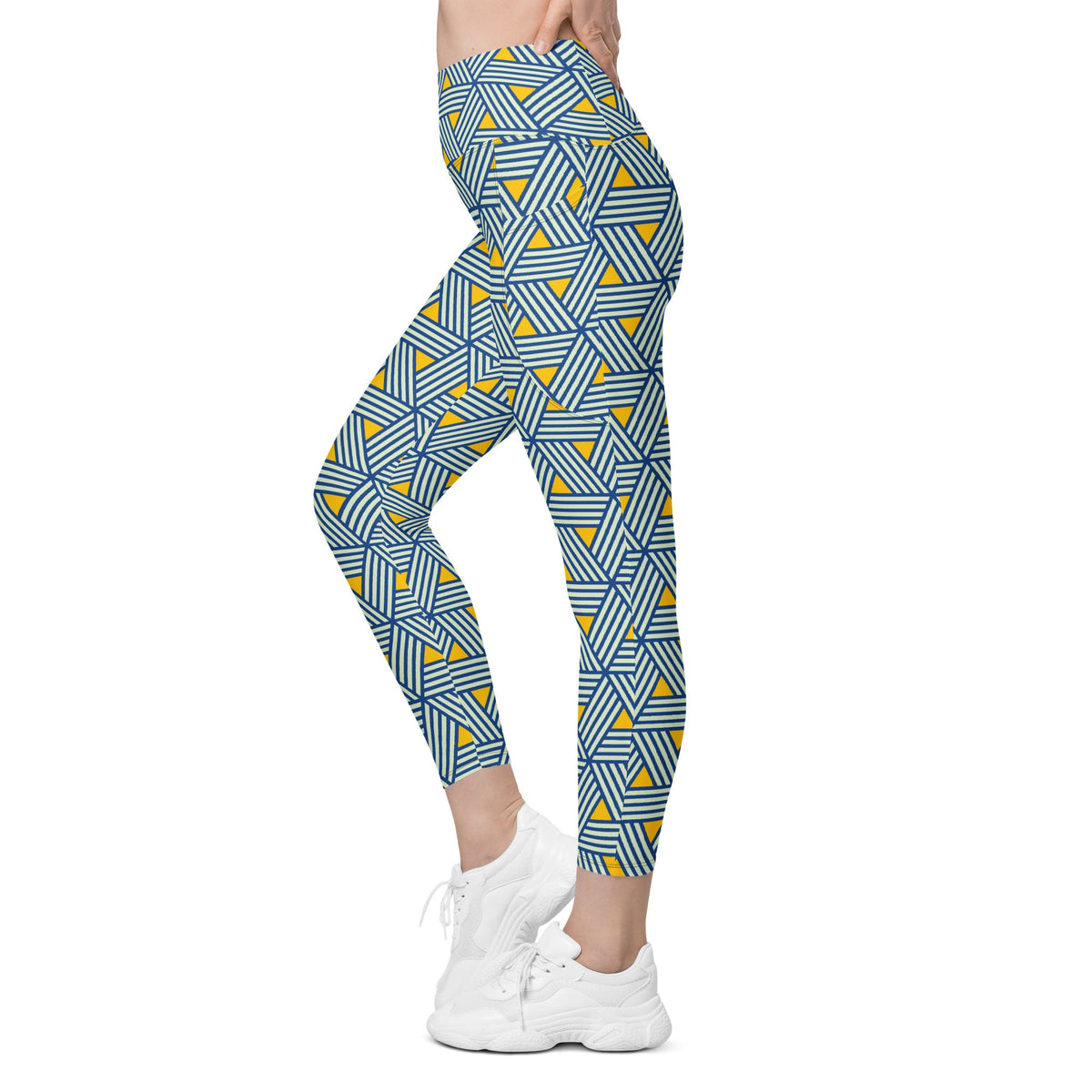 model wearing the Geneva Sculpt Leggings featuring a pattern of interweaved blue lines in yellow background.